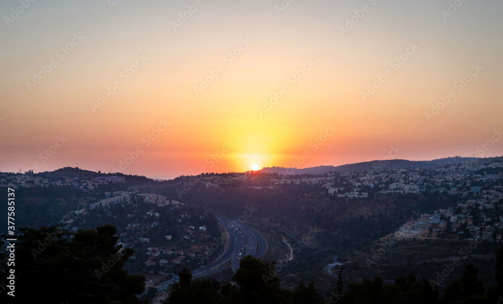 Sunset over the Jerusalem mountains, the neighborhoods in the west of the city, and road number 1