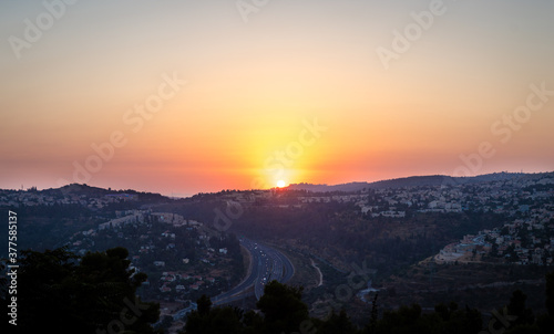Sunset over the Jerusalem mountains, the neighborhoods in the west of the city, and road number 1