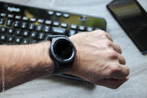 Smartwatch on the wrist. Held in a way that makes it easy to look at it