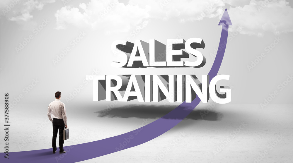 Rear view of a businessman standing in front of SALES TRAINING inscription, successful business concept Rear view of a businessman standing in front of SALES TRAINING inscription, successful business concept