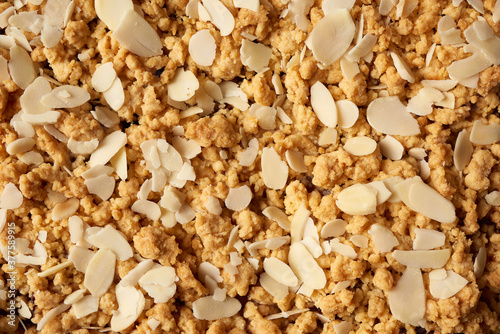 texture of baked crumble pie with fruit filling and sprinkled with grated almonds