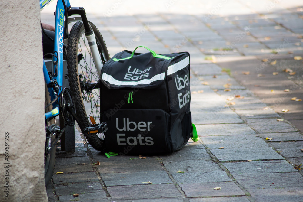 Mulhouse - France - 12 September 2020 - Closeup of Uber Eats backpack  posing near a bicycle in the street Stock Photo | Adobe Stock