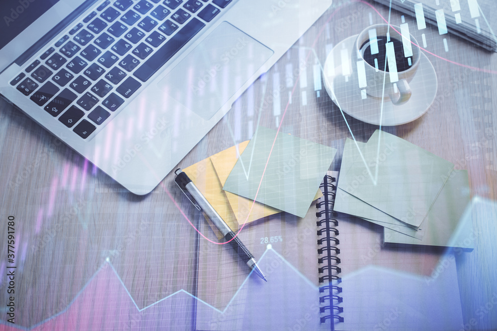 Stock market graph and top view computer on the table background. Double exposure. Concept of financial education. Stock market graph and top view computer on the table background. Double exposure. Concept of financial education.