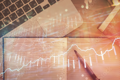 Stock market chart and top view computer on the table background. Double exposure. Concept of financial analysis.