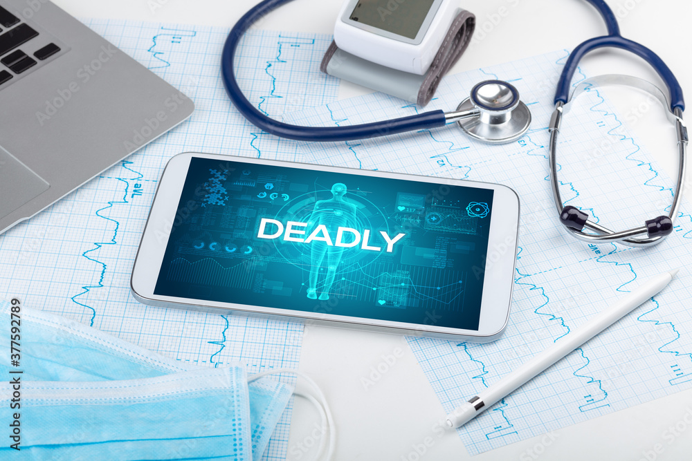 Tablet pc and doctor tools with DEADLY inscription, coronavirus concept Tablet pc and doctor tools with DEADLY inscription, coronavirus concept
