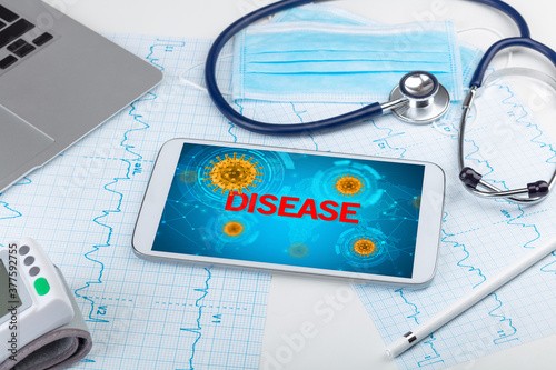Close-up view of a tablet pc with DISEASE inscription, microbiology concept