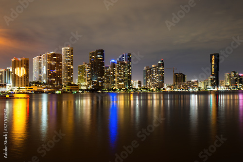 Miami skyline. Miami Florida  sunset panorama with colorful illuminated business and residential buildings and bridge on Biscayne Bay.