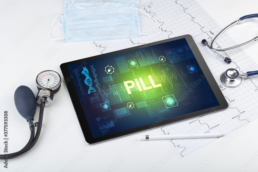 Tablet pc and medical stuff with PILL inscription, prevention concept Tablet pc and medical stuff with PILL inscription, prevention concept