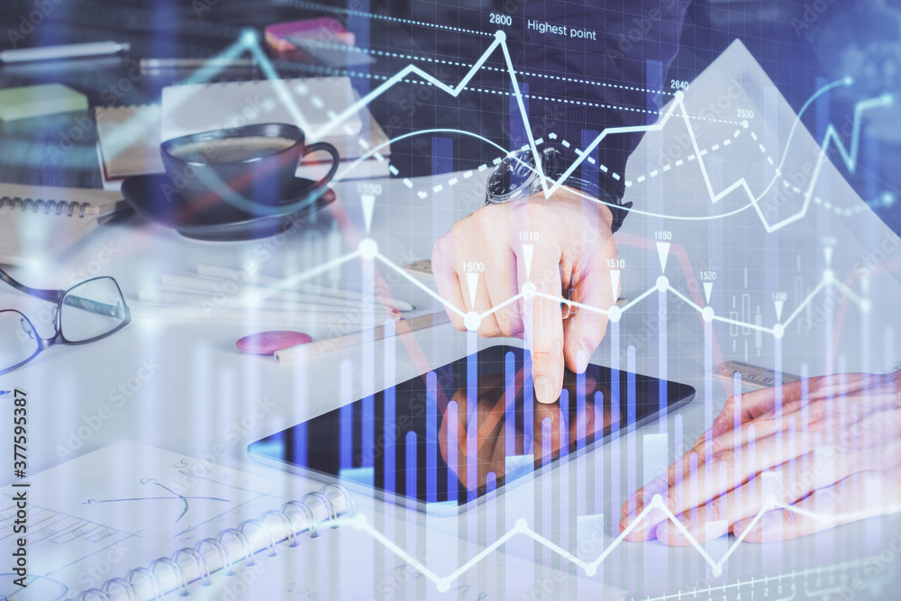 Double exposure of man's hands holding and using a digital device and forex graph drawing. Financial market concept. Double exposure of man's hands holding and using a digital device and forex graph drawing. Financial market concept.