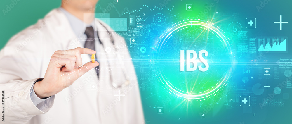Close-up of a doctor giving you a pill with IBS abbreviation, virology concept Close-up of a doctor giving you a pill with IBS abbreviation, virology concept