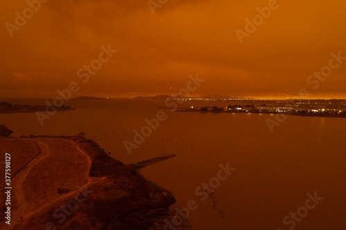 drone pictures of albany, CA beach with orange glow due to wildfires