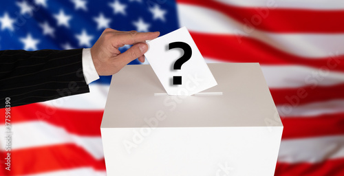 A person puts a ballot with...