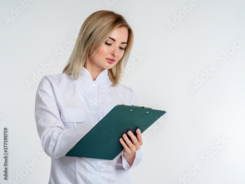 A girl in a white coat with...