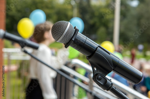 The microphone stands on a stand in the open air