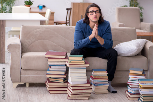 Young male student preparing for exams at home