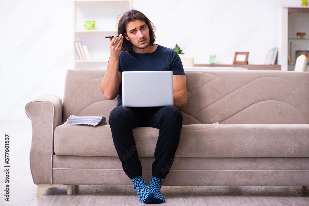 Young man employee working from house