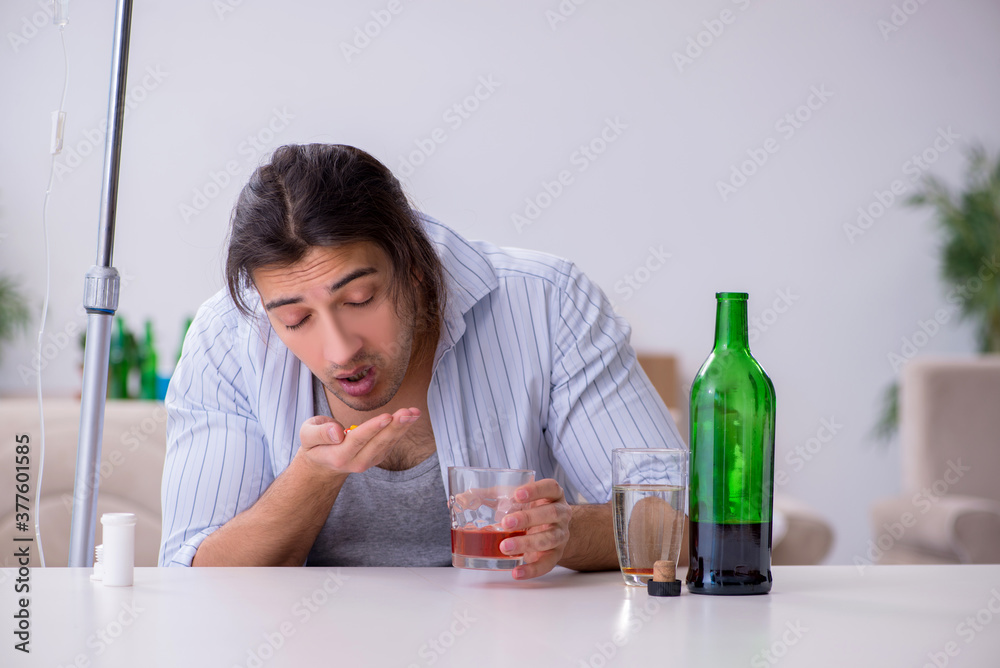 Young man in alcohol addiction treatment concept Young man in alcohol addiction treatment concept