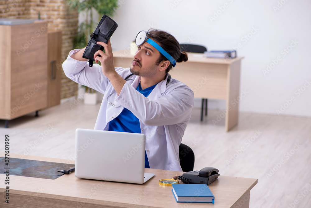 Young male doctor working in the clinic Young male doctor working in the clinic