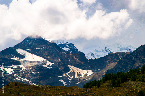 Swiss Mountains and glacier lakes as seen from the Bernini Express Train from Italy to St Moritz in Switzerland,which is a journey full of wonderful scenery, mountain peaks and deep valleys