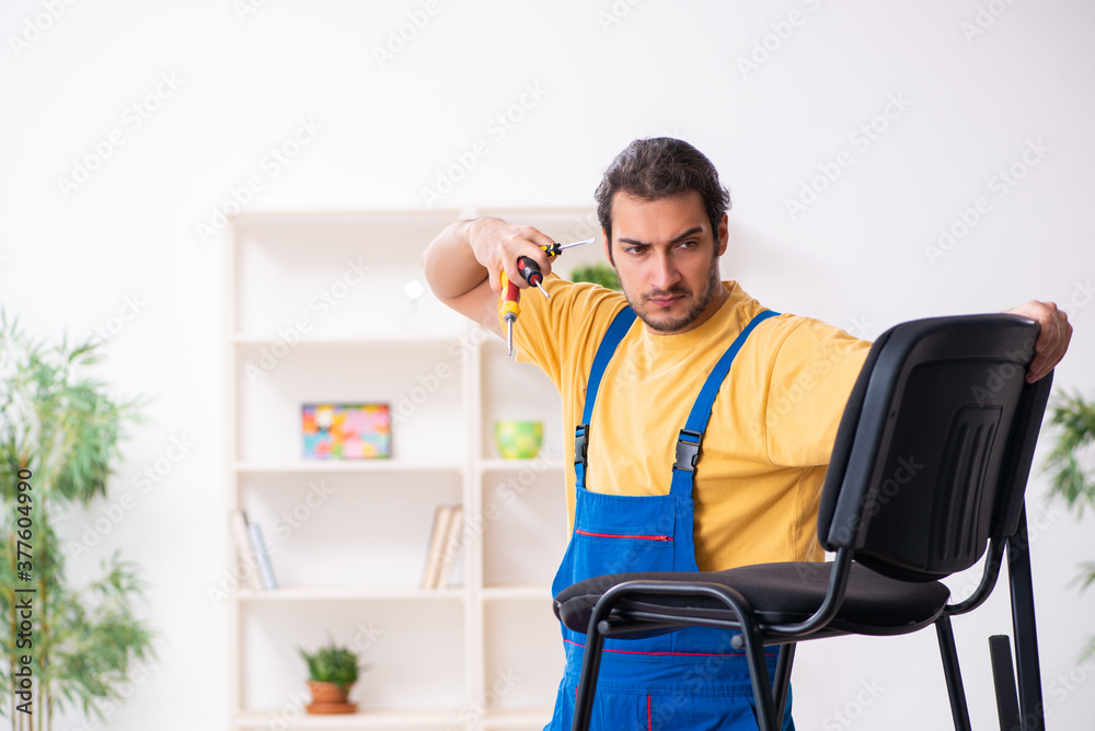 Young male carpenter working indoors