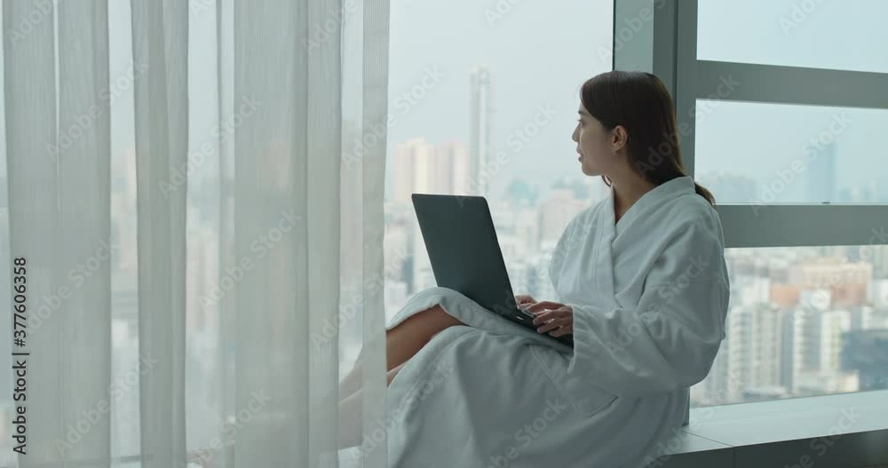 Woman work on laptop computer and enjoy city view Woman work on laptop computer and enjoy city view