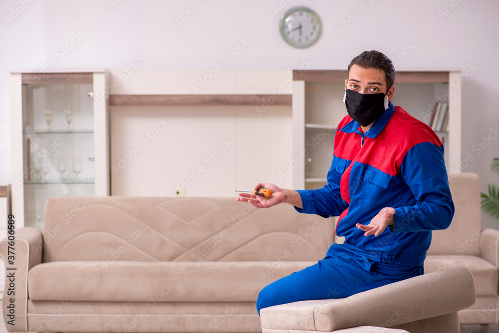 Young carpenter working indoors during pandemic disease Young carpenter working indoors during pandemic disease