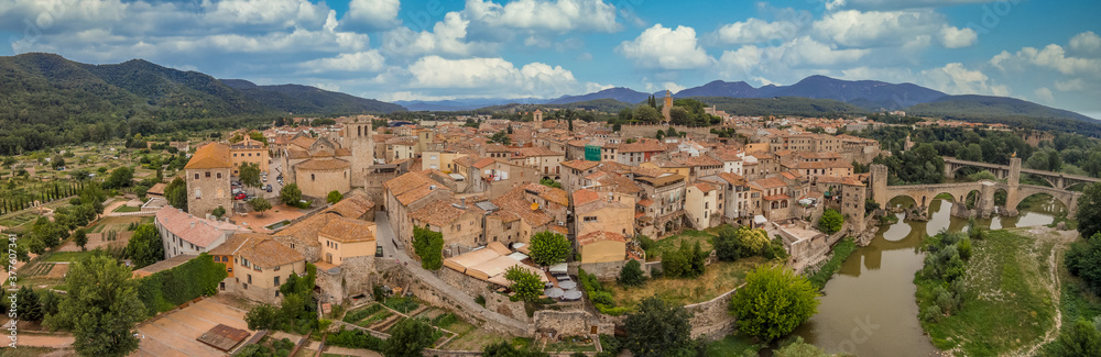Aerial panorama view of medieval Besalu, home to the older synagogue in Catalonia Spain with cloudy blue sky