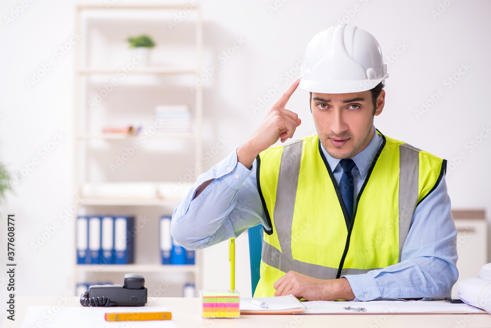 Young male architect working in the office Young male architect working in the office