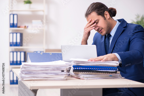 Young male employee unhappy with excessive work