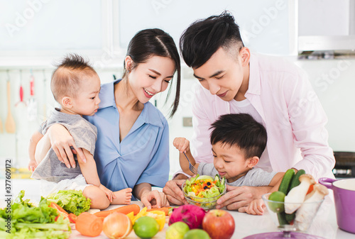 happy family preparing dinner with healthy  food in kitchen