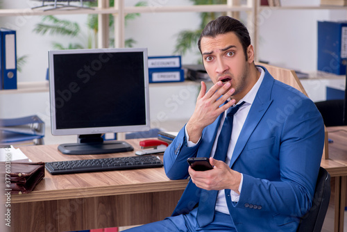 Young male employee businessman at workplace