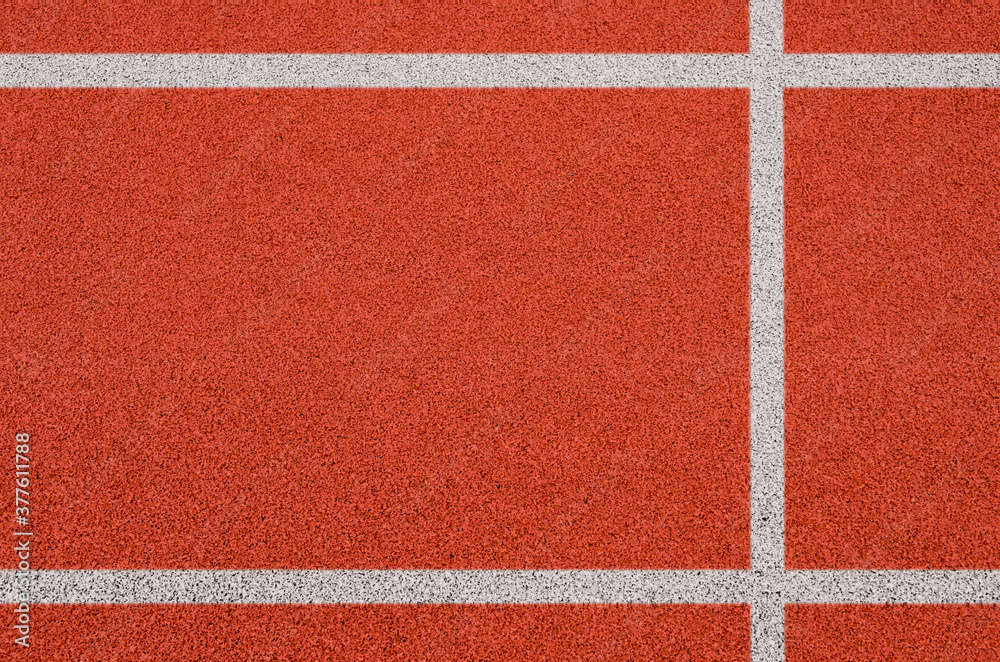 Fototapeta premium Top view of the running track rubber lanes cover texture with white line marking for background.
