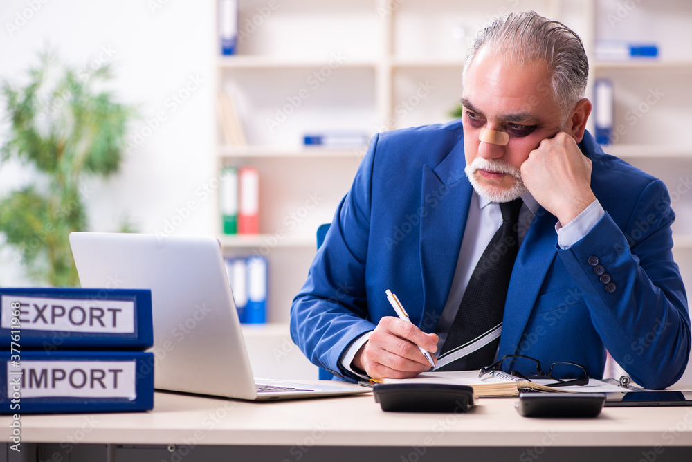 Old face injured employee sitting in the office Old face injured employee sitting in the office