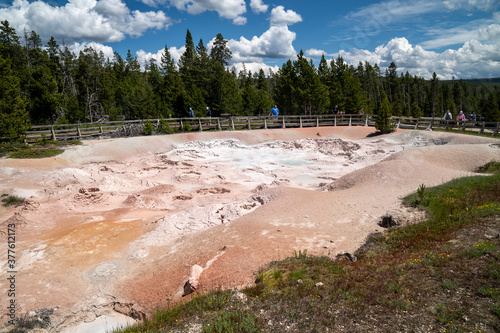 Tourists watch the fountain paint pots and mud pots in Yellowstone National Park