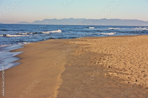 relaxing walks on the sandy beach of Versilia on a sunny day in Italian winter