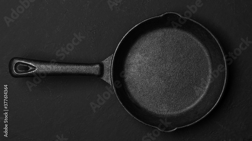 Cast iron pan on a black background