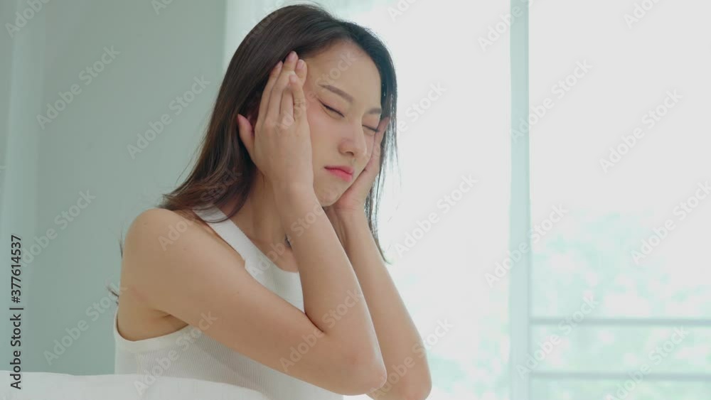 Asian young Woman has a Migraine and headache after wake up in the morning,Healthcare Concept Asian young Woman has a Migraine and headache after wake up in the morning,Healthcare Concept