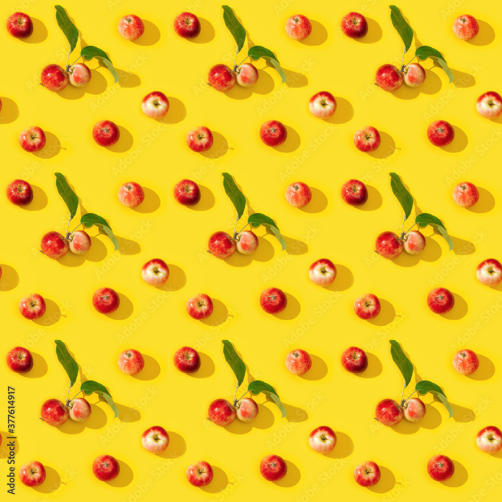 Seamless regular creative pattern from small red apples and green leaves with dark shadows. Seamless regular creative pattern from small red apples and green leaves with dark shadows.