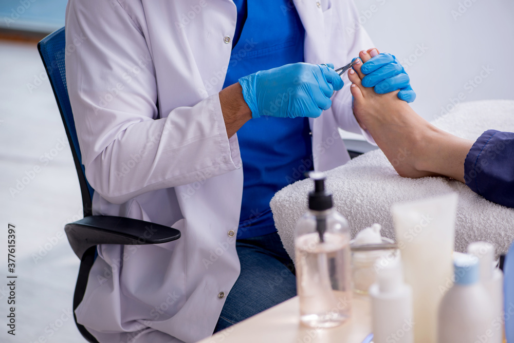 Podiatrist treating feet during procedure Podiatrist treating feet during procedure