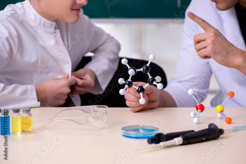 Young father and son chemists in the lab