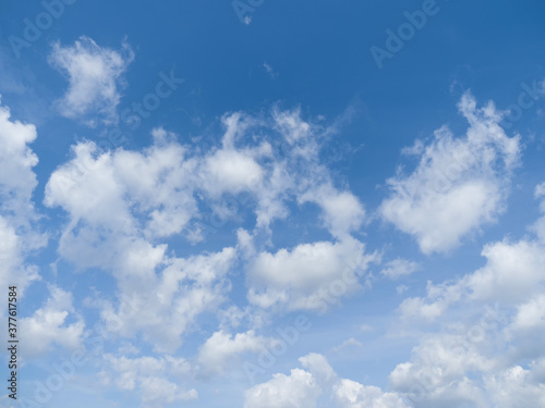 Whimsical clouds in the blue sky. Summer day