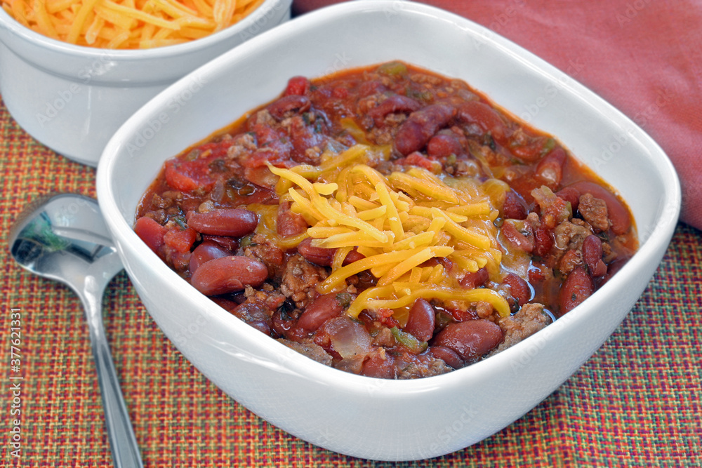 Bowl of Homemade Chili topped with Shredded Cheddar cheese. Bowl of Homemade Chili topped with Shredded Cheddar cheese.