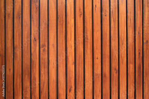 Old vintage red brown wood lath wall cladding for background and texture images. photo
