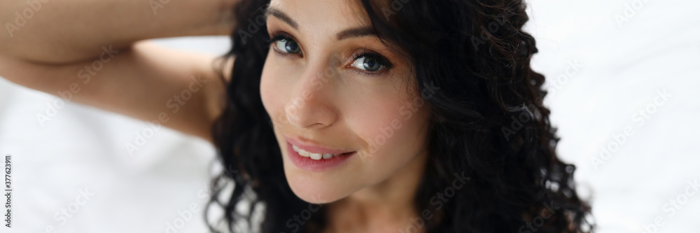 Beauty woman portrait against white bed background. Facial skin care concept Beauty woman portrait against white bed background. Facial skin care concept