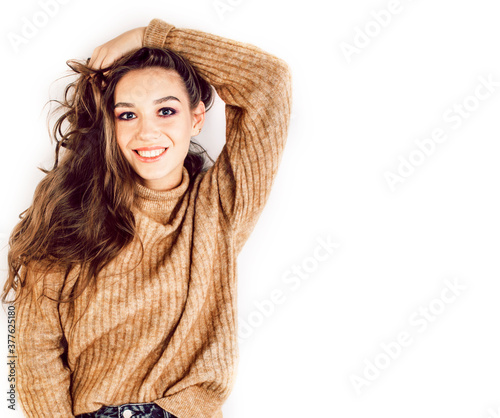 young pretty teenage hipster girl posing emotional happy smiling on white background, lifestyle people concept