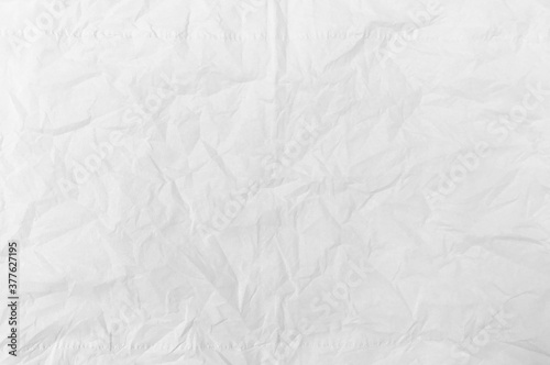 The background is white crumpled paper. Texture of paper with kinks and dents, old and dilapidated. wrinkle recycle paper texture background.