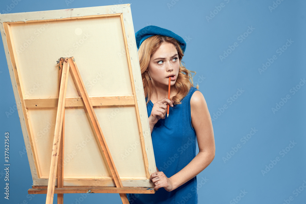 Woman artist blue take easel hobby drawing Creative blue background