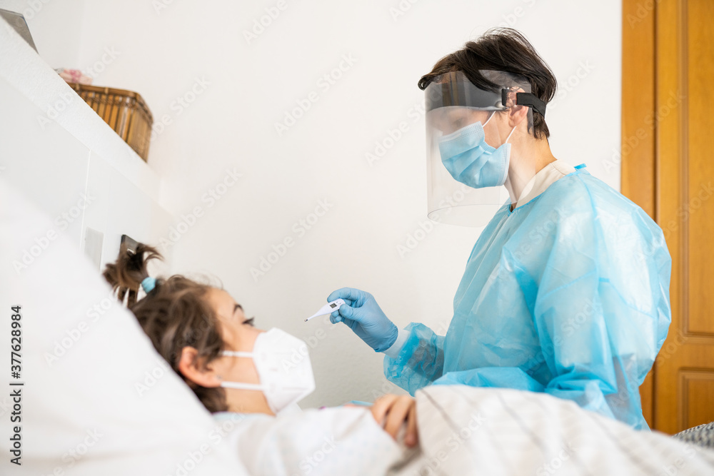 Doctor examining a little girl with a stethoscope at home. Doctor examining a little girl with a stethoscope at home.