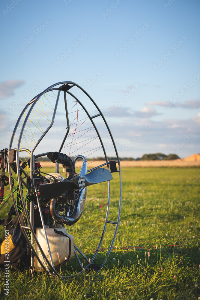 Closeup of a petrol-powered paramotor with a propeller and protection for individual paragliding flights. Preparation for wing flight. Extreme sports.