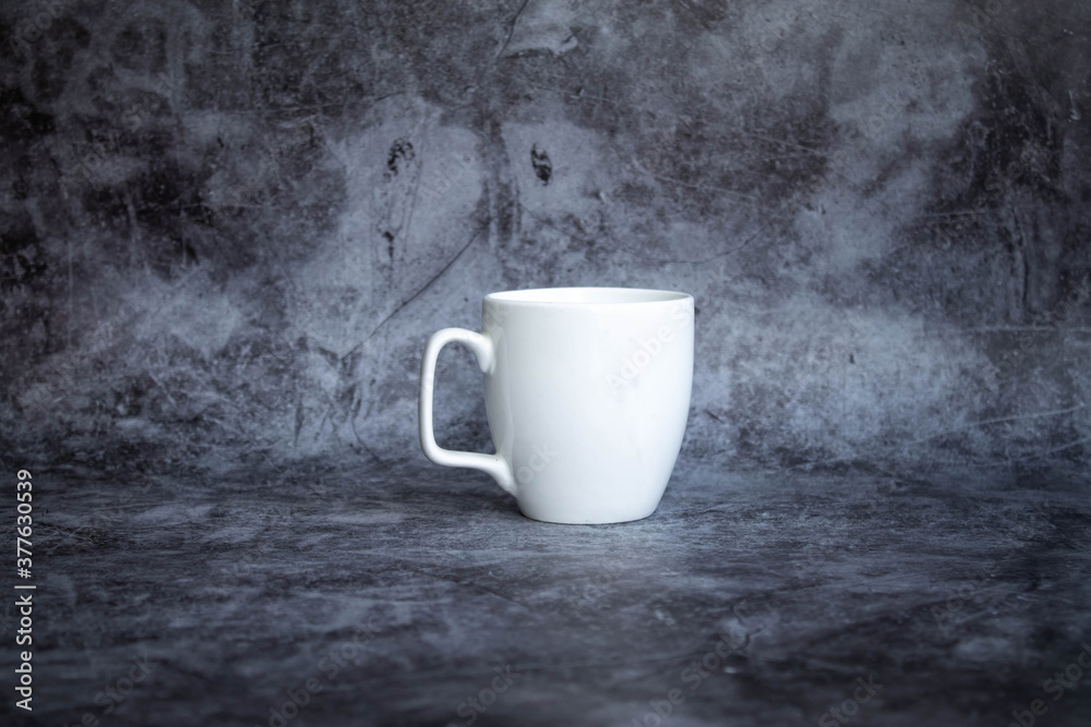 white cup for coffee on a dark background. side view, isolate white cup for coffee on a dark background. side view, isolate